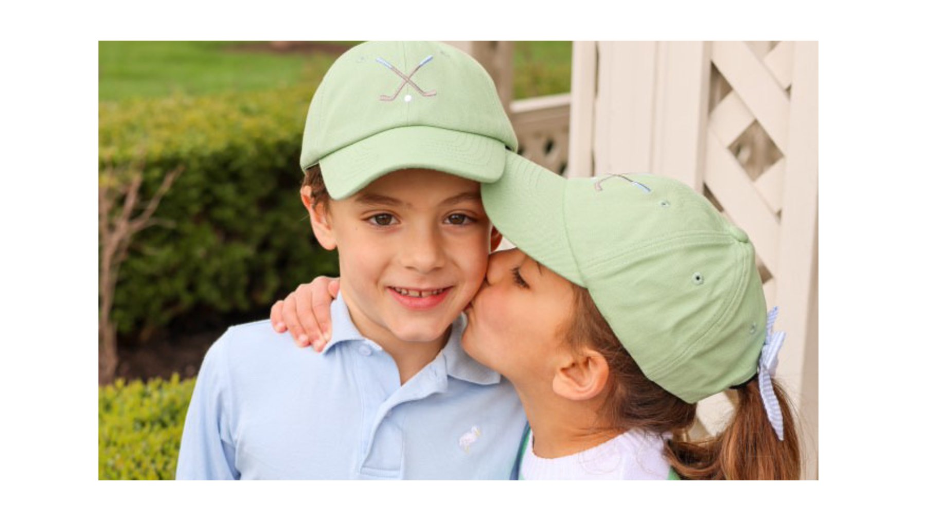 Children wearing cute embroidered baseball caps