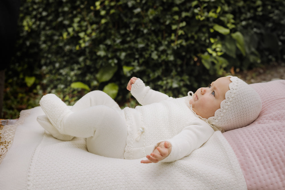elegany baby dressed in wool knit ivory set