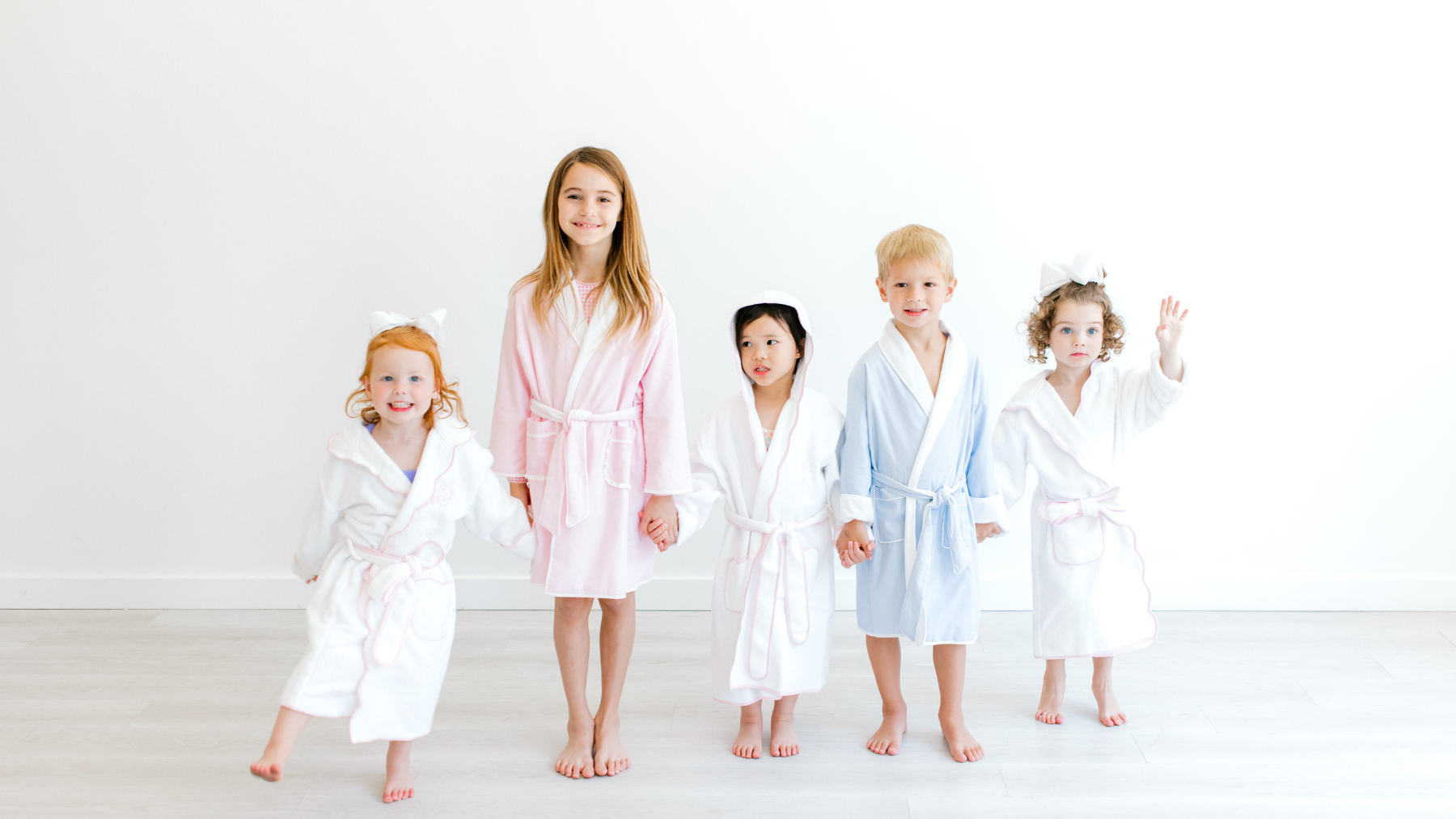 Children dressed in terrycloth bathrobes