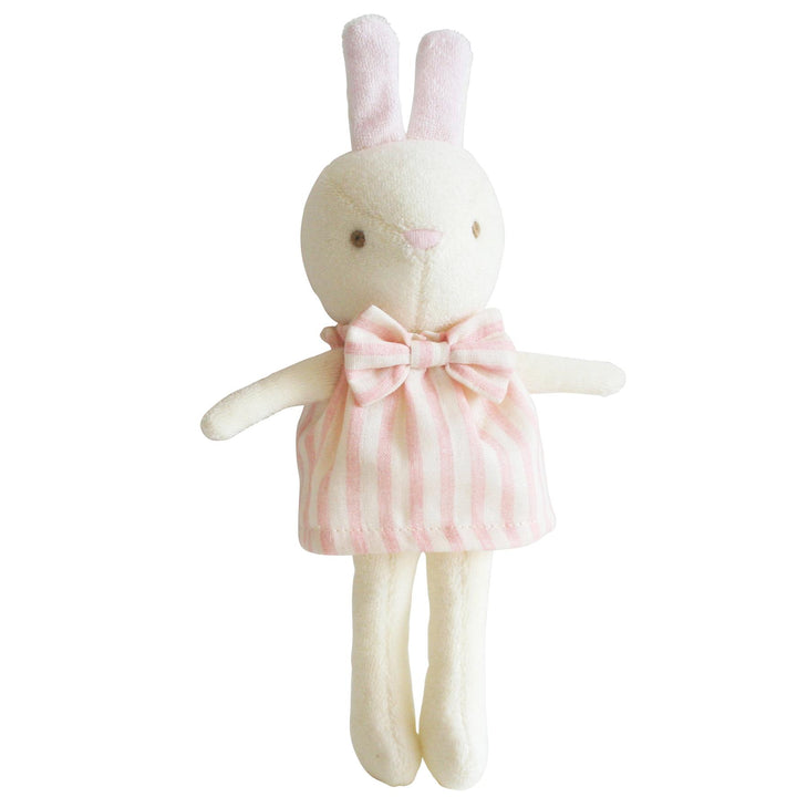 Stuffed bunny toy with a pink dress on a white background