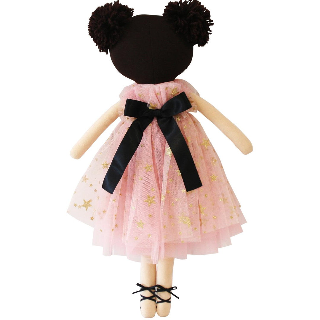 Doll with a pink dress and black bow on a white background
