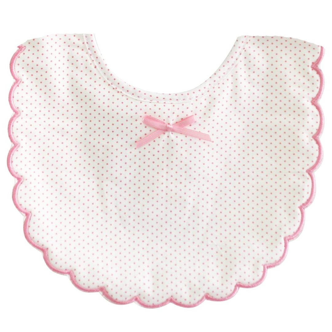 Baby bib with pink scalloped edge and bow on a white background