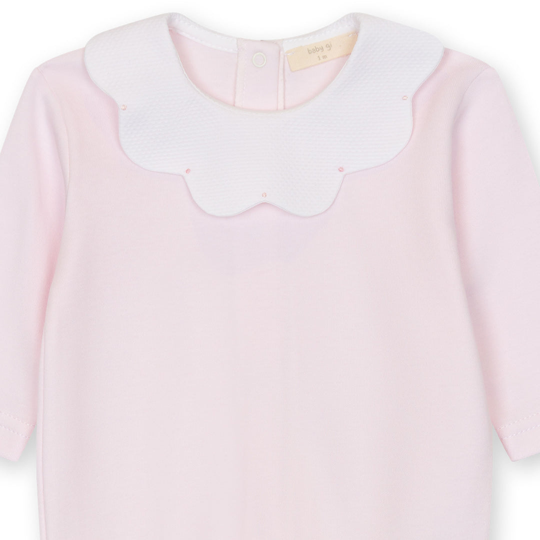 Close up of pink baby footie with scalloped collar