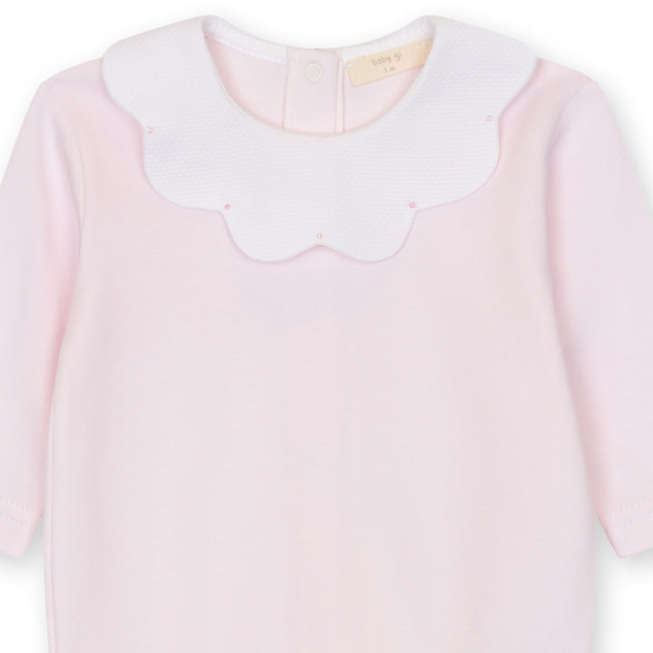 Close up of pink baby footie with scalloped collar