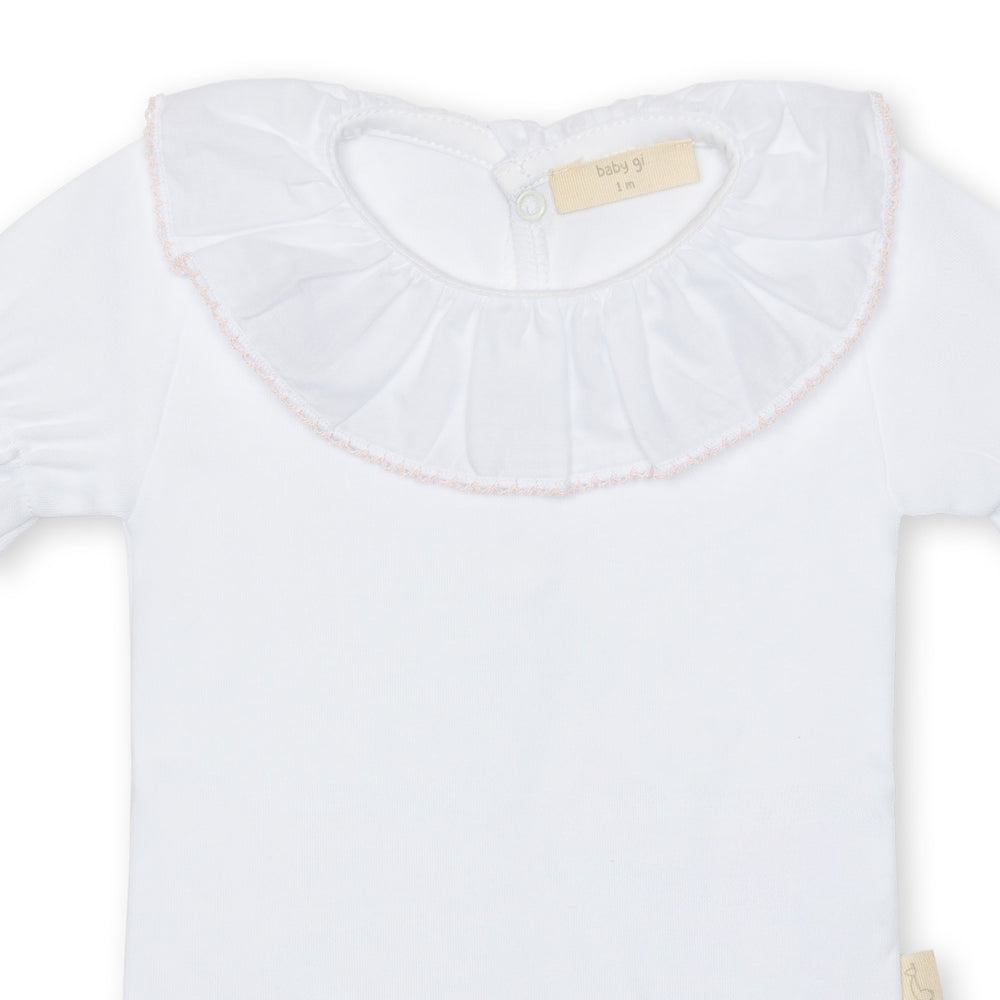 White long-sleeve shirt with ruffled collar on a white background