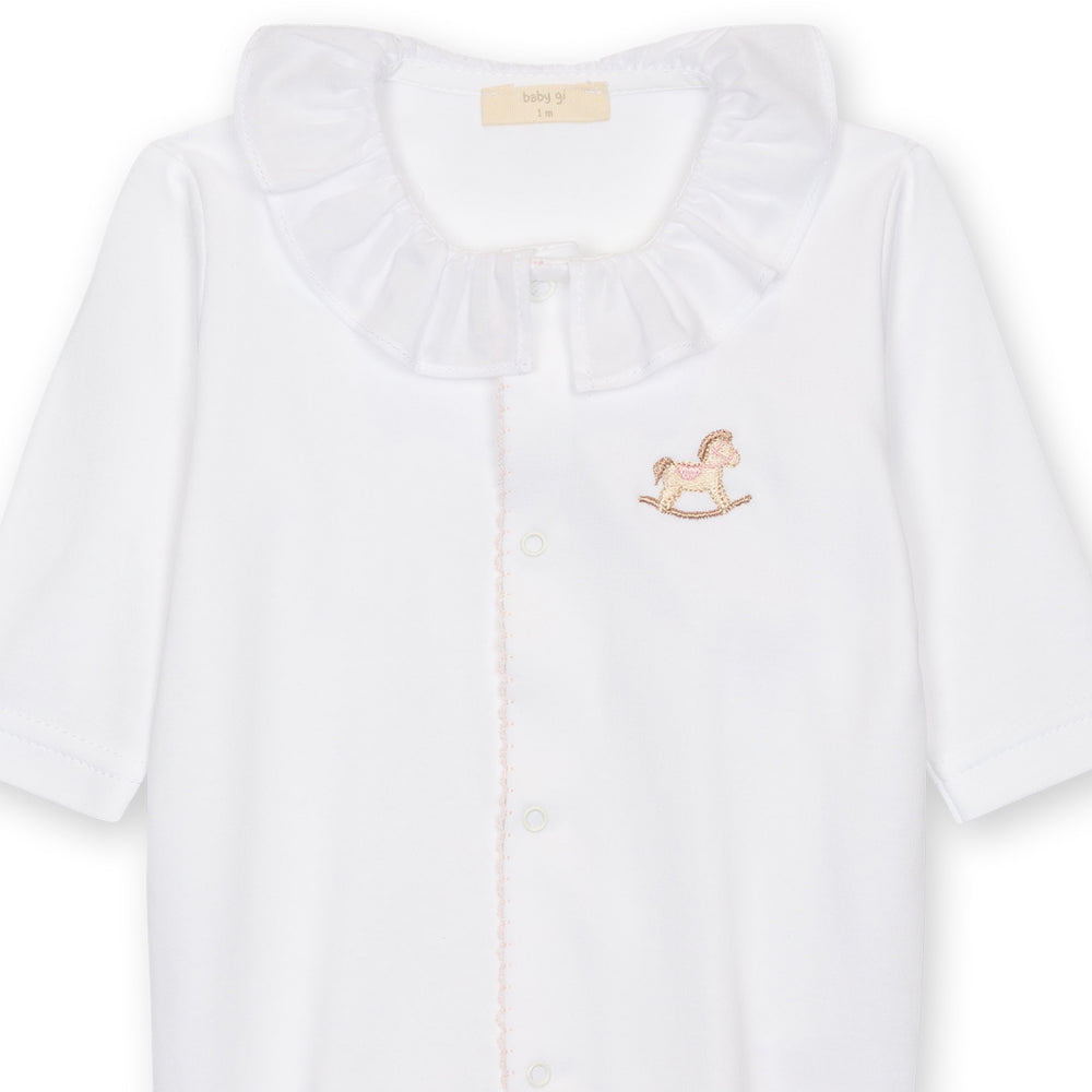 White baby outfit with a rocking horse emblem on a white background