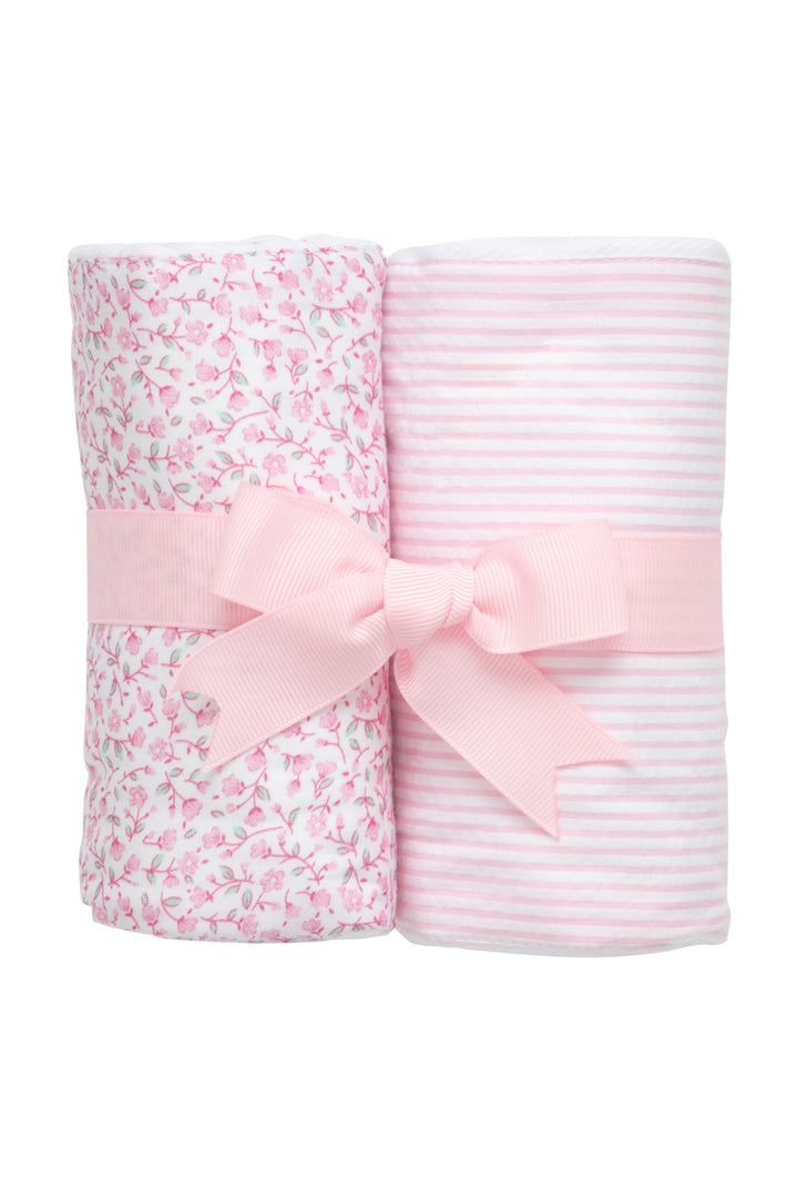 set of two pink burp cloths rolled with a ribbon tied