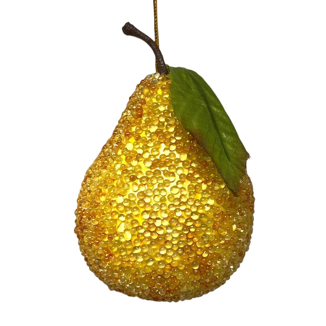 A decorative pear-shaped hanging ornament covered in textured yellow and gold glitter-like beads, with a green leaf and brown stem, suspended by a thin gold string against a plain white background.