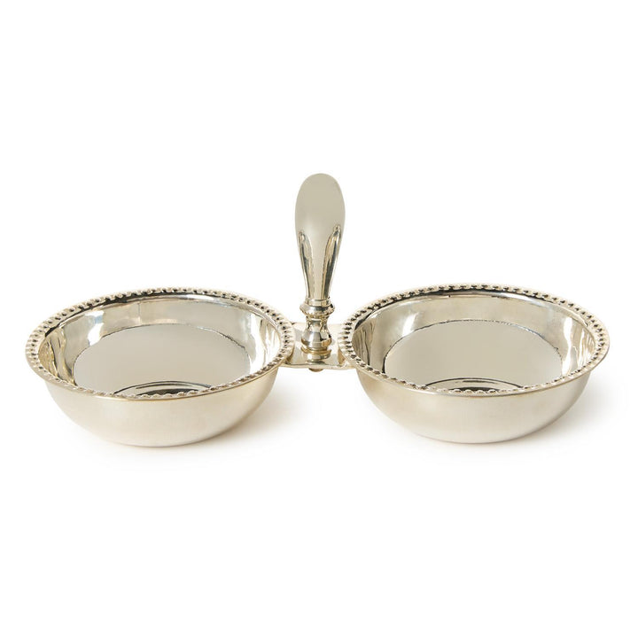 Silver two-sectioned dish with a handle on a white background