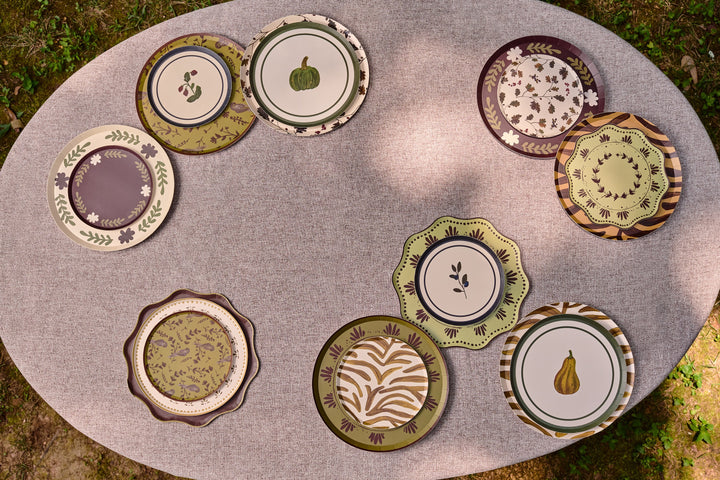 Table Two Studio paper plate collection arranged outdoors on a table, featuring the green Bistro Appetizer plate