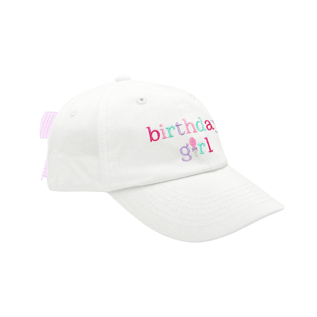White cap with 'birthday girl' text on a white background