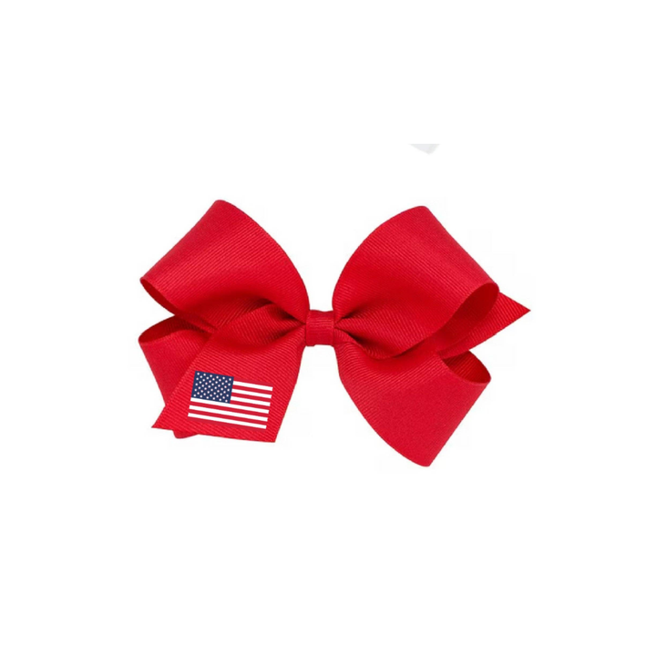 Red hair bow with an American flag on a white background