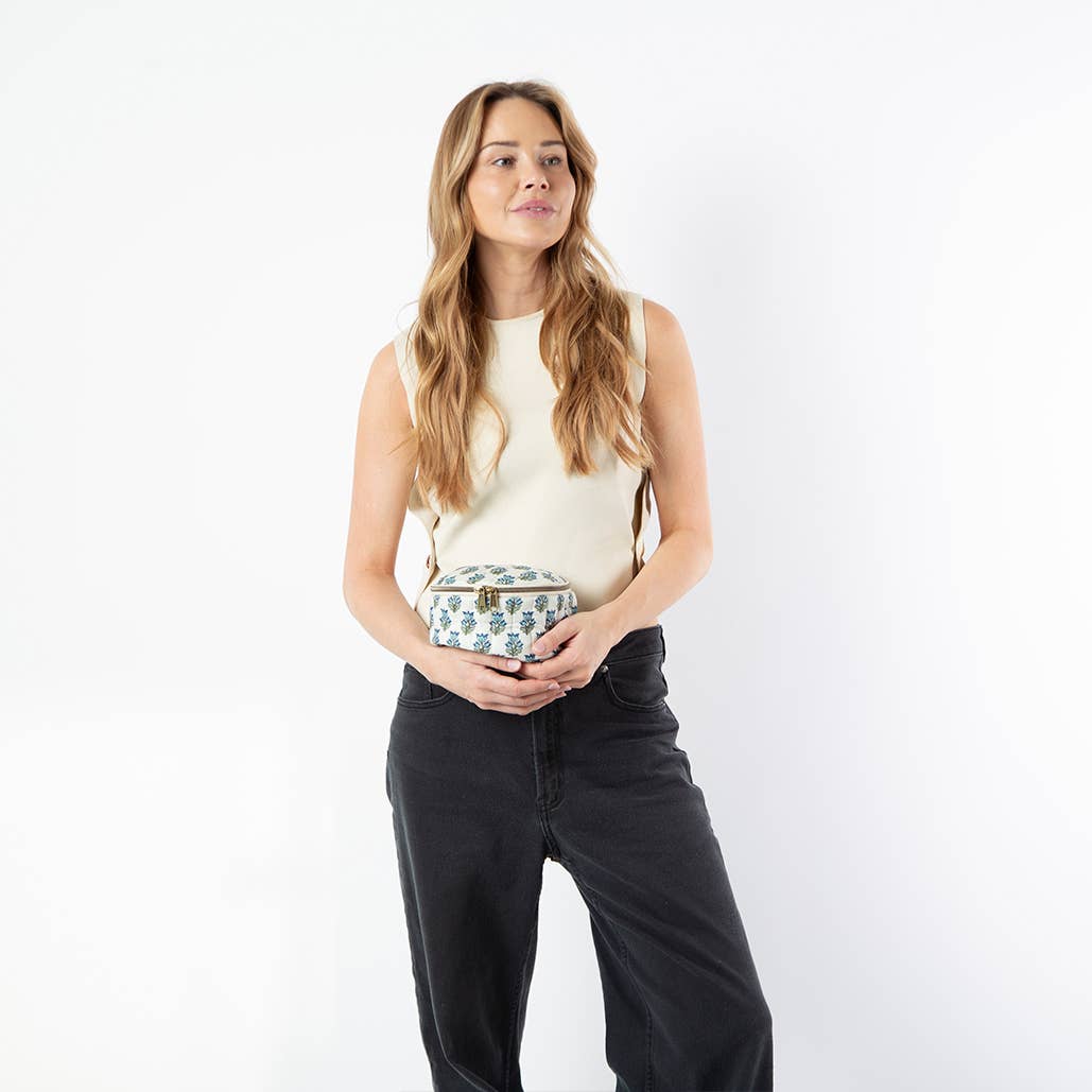 Woman holding a patterned handbag against a white background