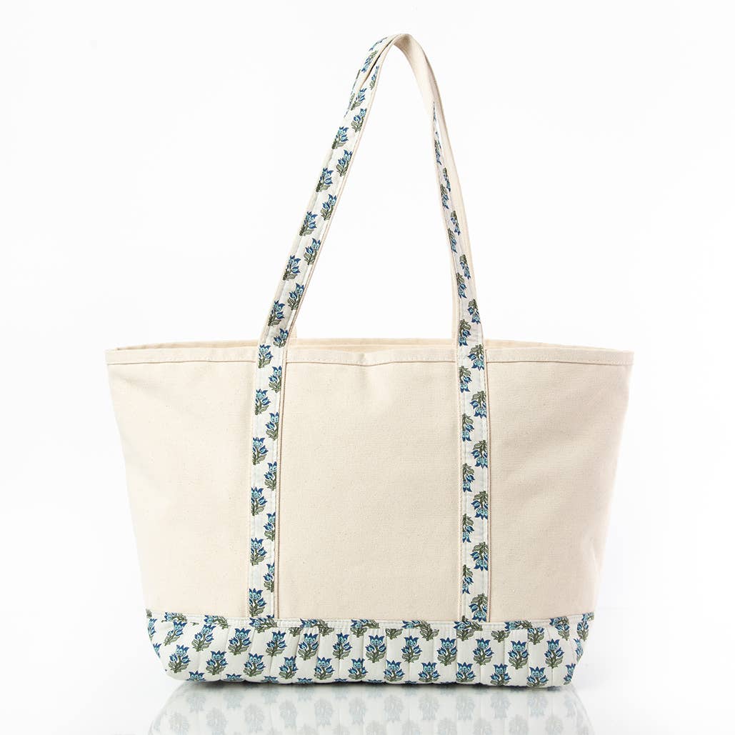 Beige tote bag with blue floral pattern on a white background