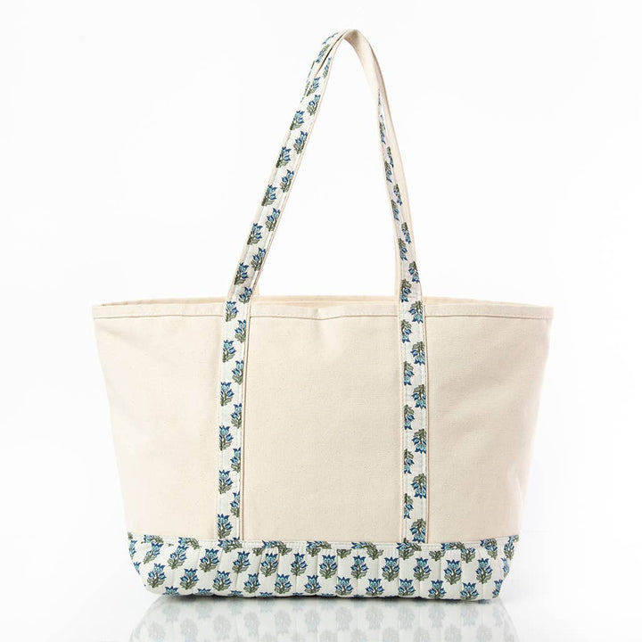 Beige tote bag with blue floral pattern on a white background