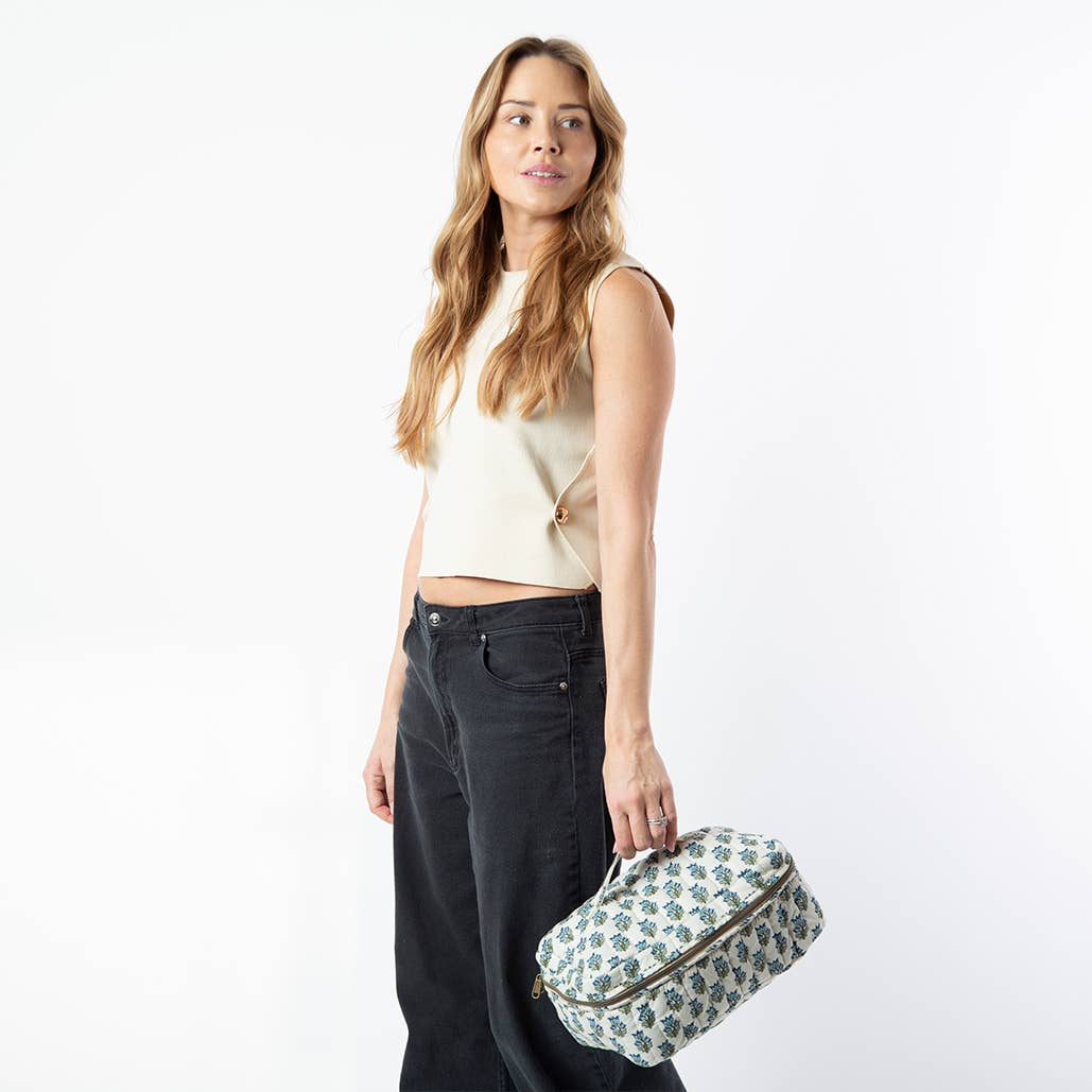 Woman holding a patterned bag against a white background
