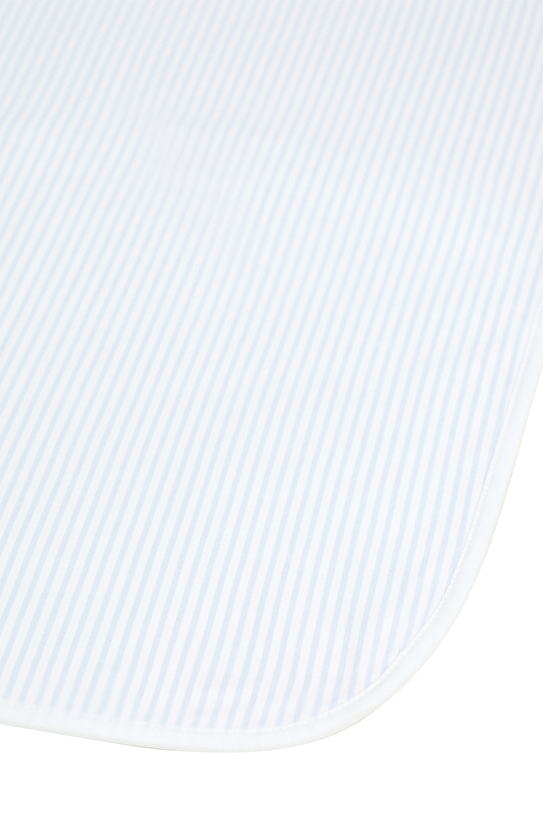 A close-up of a white textured fabric with fine vertical stripes and a rounded corner, likely a baby blanket or swaddle.