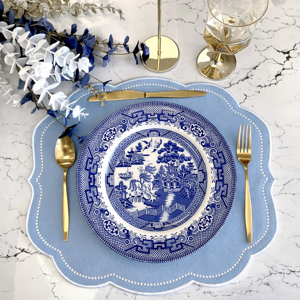 Blue Elegant Table Setting with Blue China on top of a Blue Embroidered Placemat