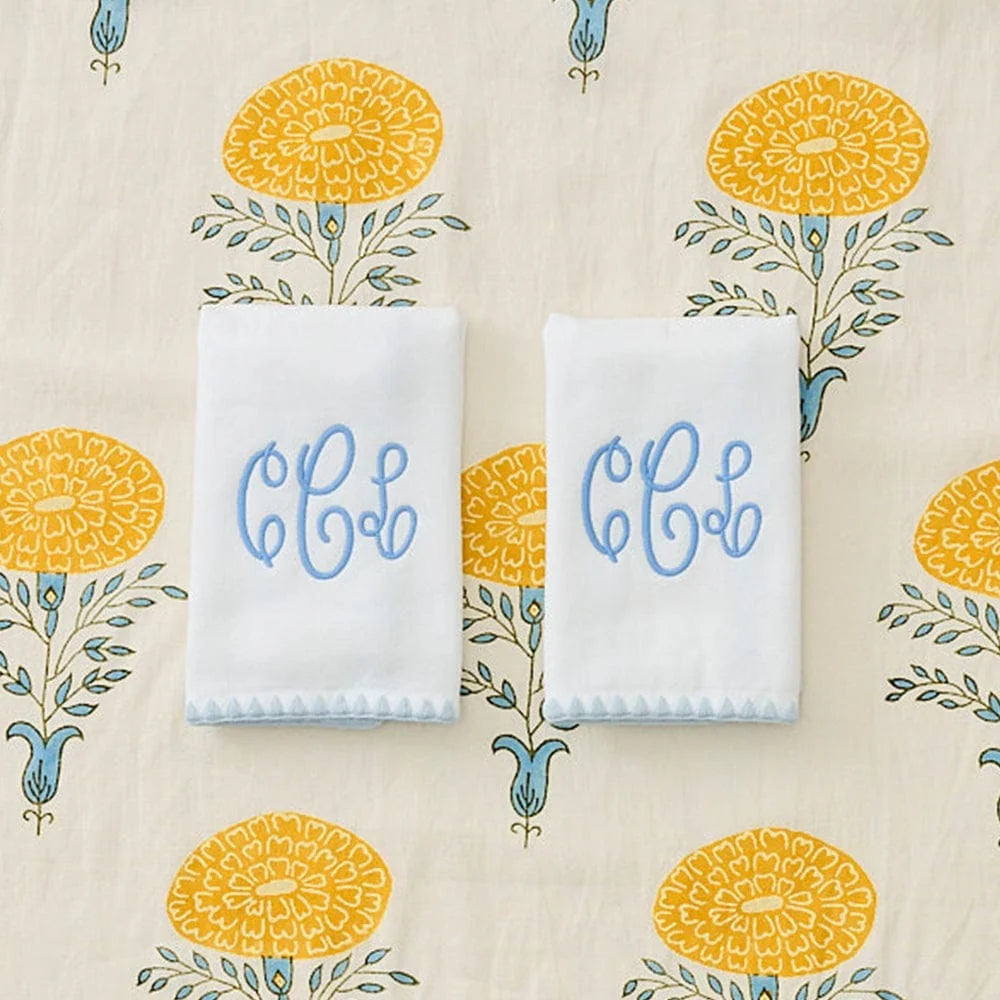 two folded powder room hand towels with monogram