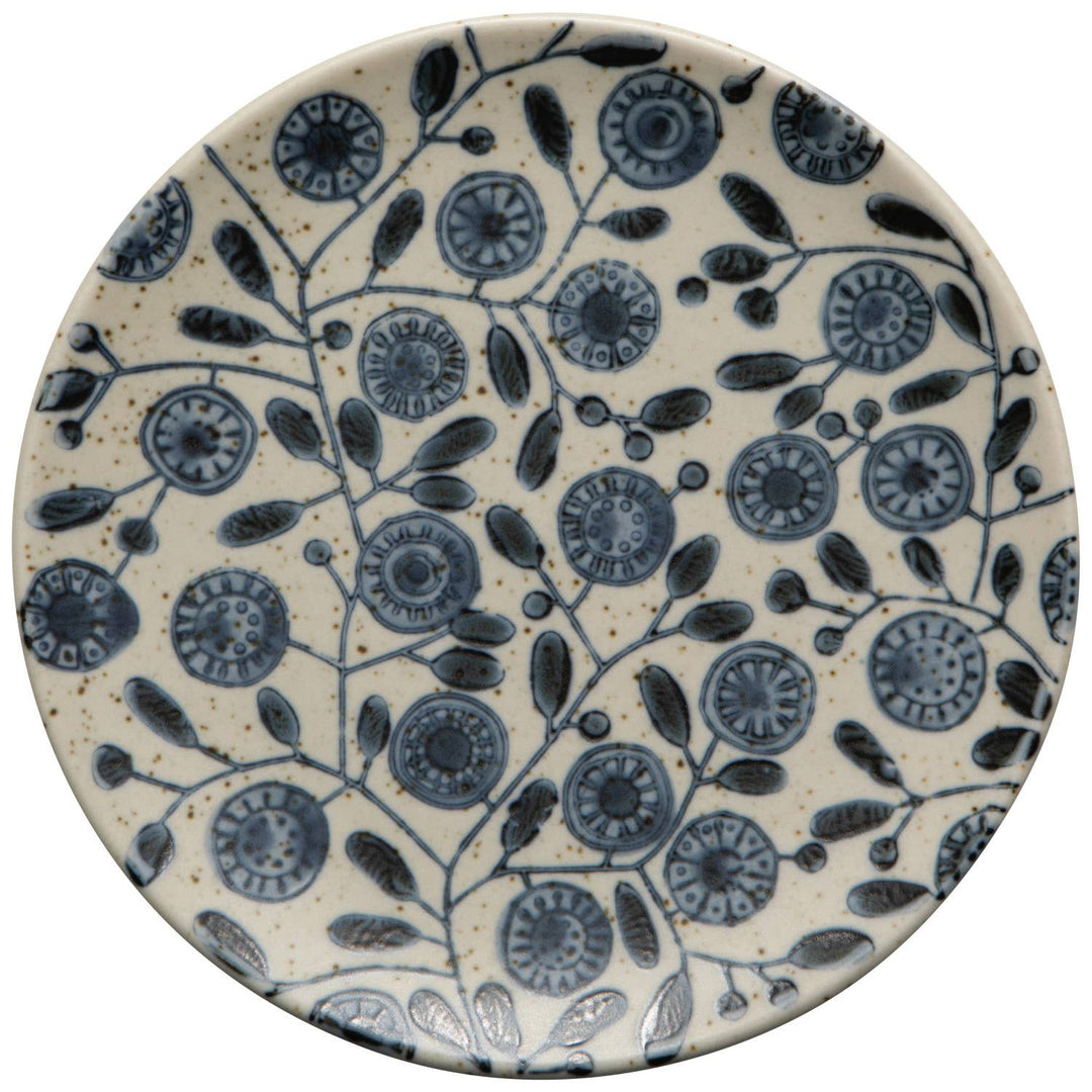 Ceramic plate with blue floral pattern on a beige background