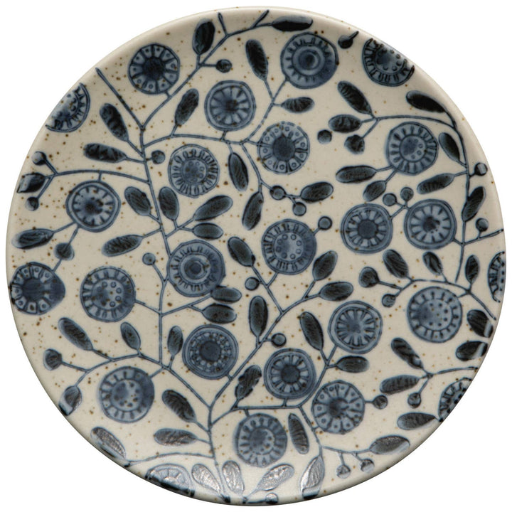 Ceramic plate with blue floral pattern on a beige background