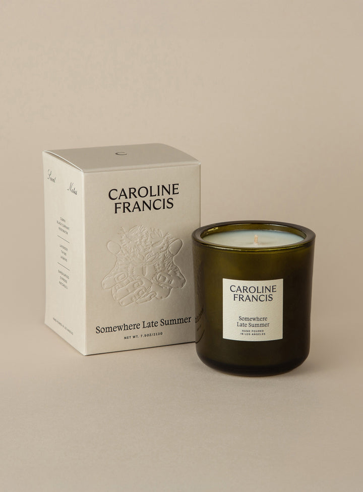 Caroline Francis candle and packaging on a beige background