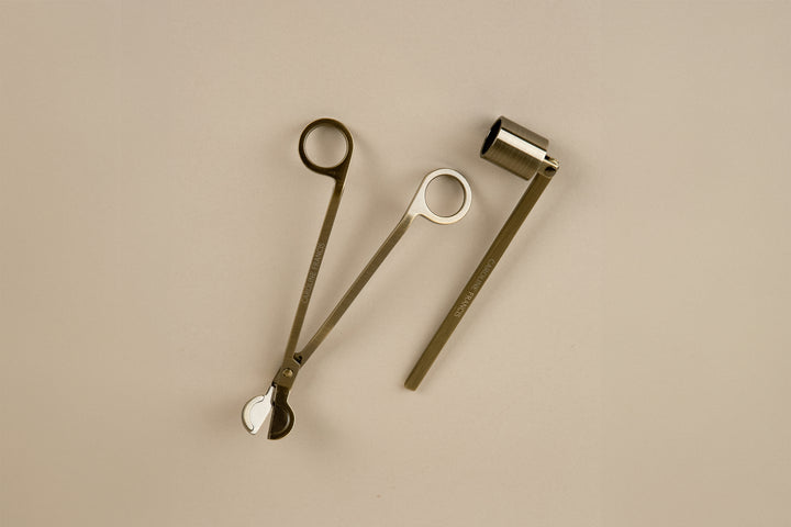 Three metallic tools on a beige background