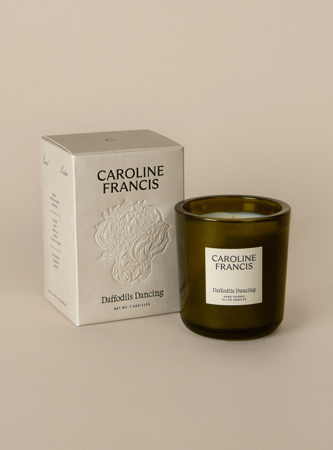 Caroline Francis candle and packaging on a beige background