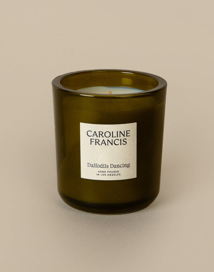 Green candle with a label on a beige background