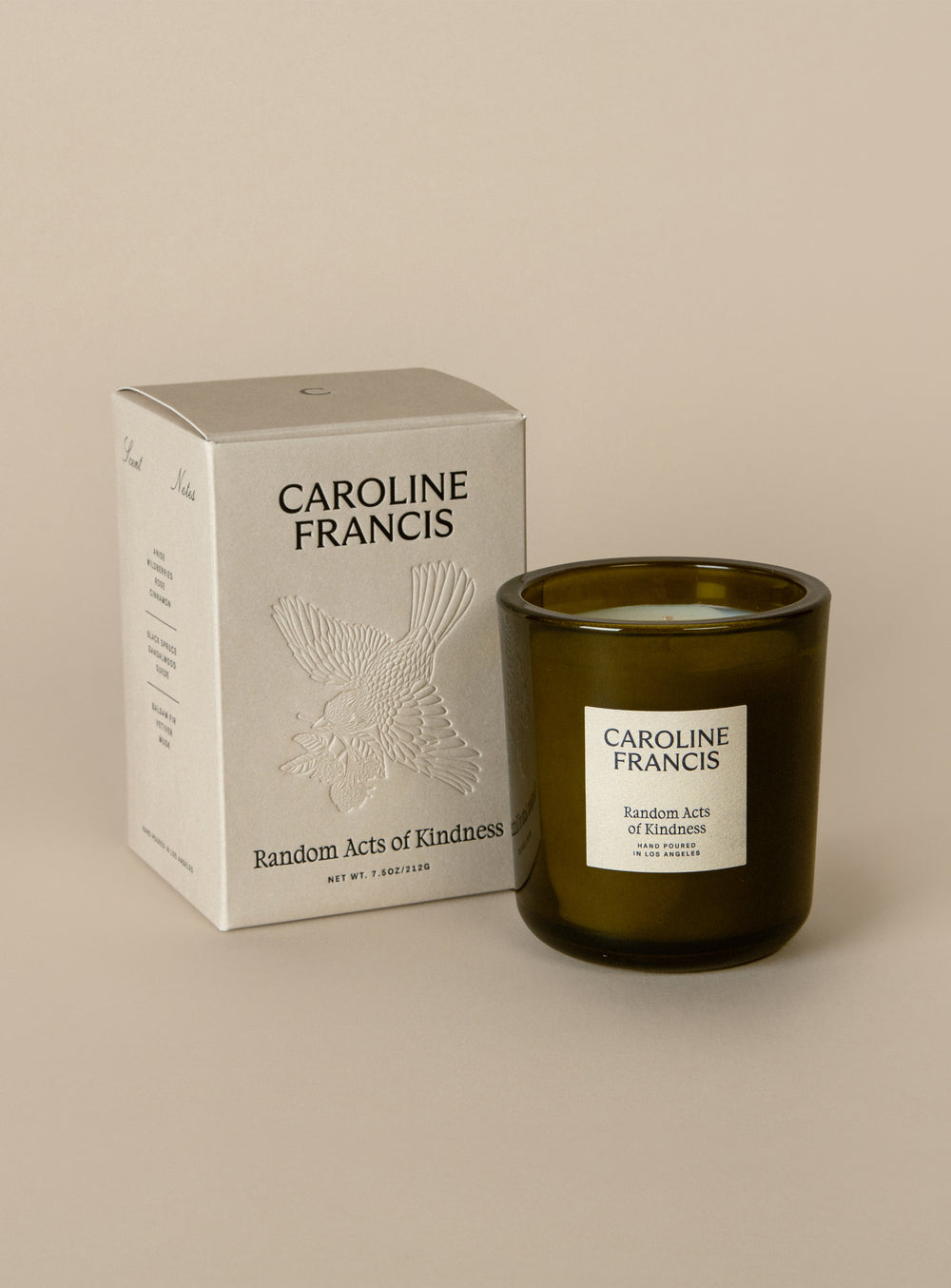 Caroline Francis candle and packaging on a beige background