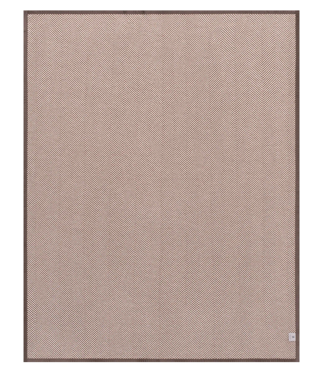 A square area rug with a fine herringbone pattern in a dusty rose pink color, finished with a dark brown border, shown flat against a white background.