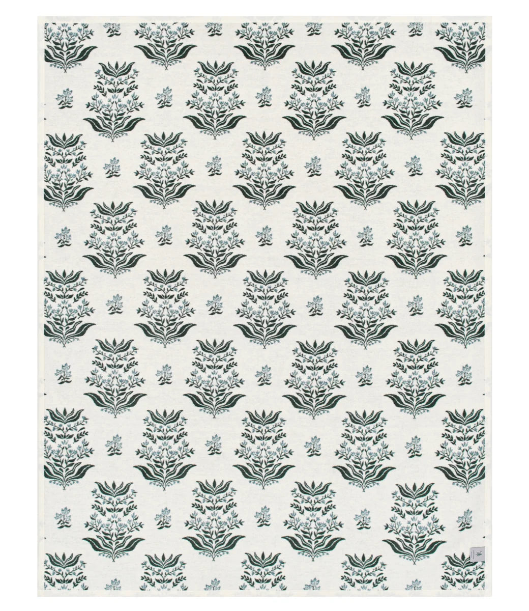 A rectangular textile or wallpaper sample with a repeating damask-style floral pattern in muted blue-gray and dark gray on an off-white background.