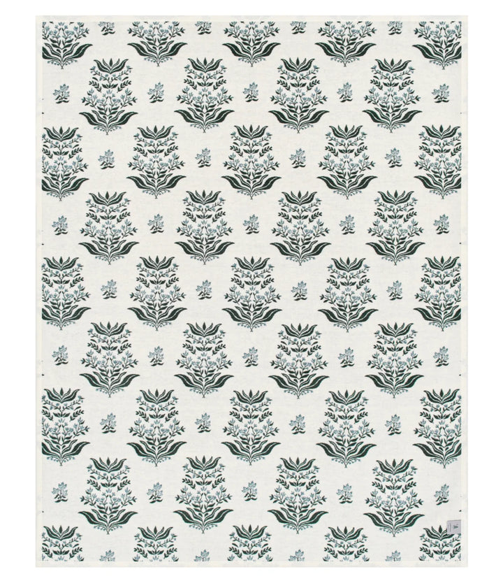 A rectangular textile or wallpaper sample with a repeating damask-style floral pattern in muted blue-gray and dark gray on an off-white background.