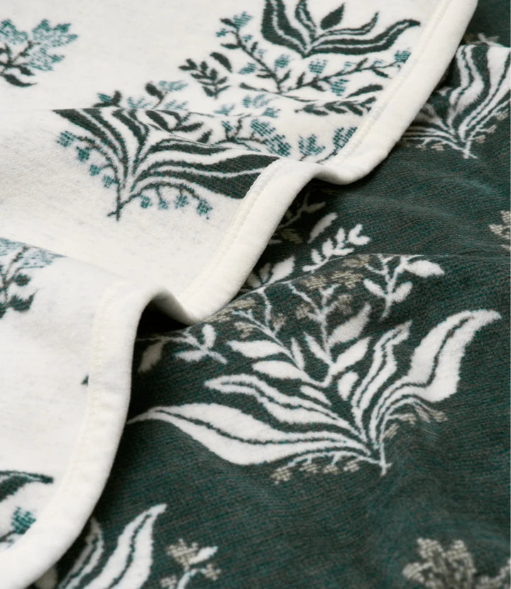 Close-up of fabric with floral pattern on a green background
