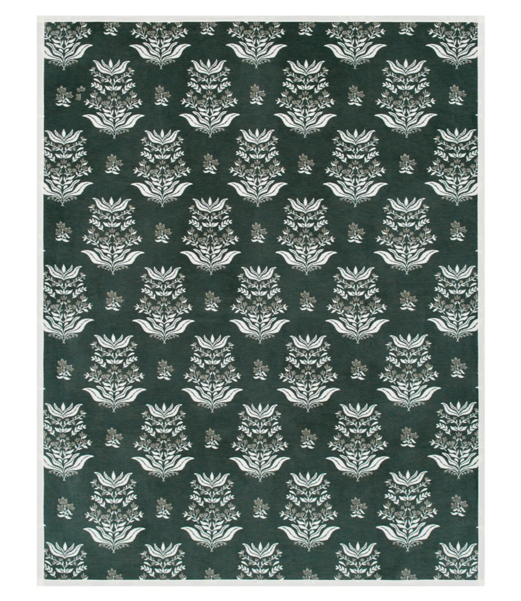 A square area rug featuring a repeating damask-style floral pattern in dark forest green and off-white, framed by a thin off-white border.
