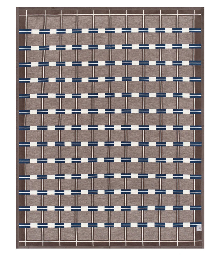 A rectangular woven area rug with a geometric pattern, featuring a taupe-brown base, navy blue horizontal bands, and off-white vertical stripes.
