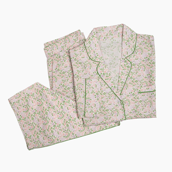 Floral pajama set with green trim on a white background