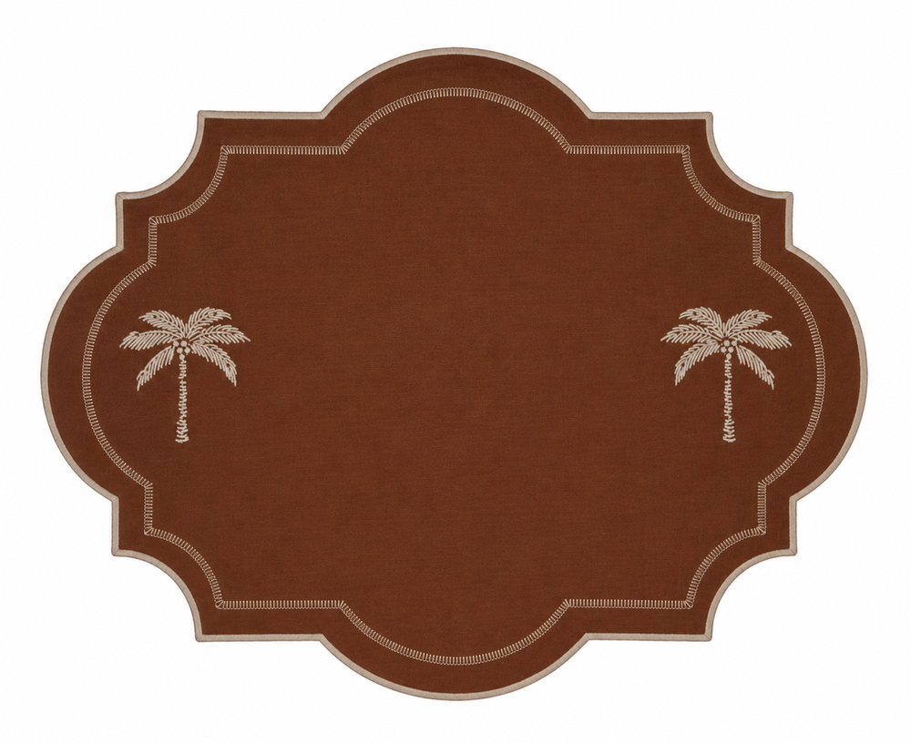 A brown oval-shaped rug with scalloped edges, featuring two light beige palm tree motifs on the left and right sides and a decorative dotted border.