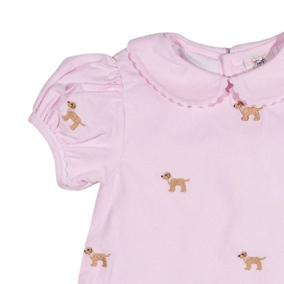 Close up of pink dress with doggy motifs