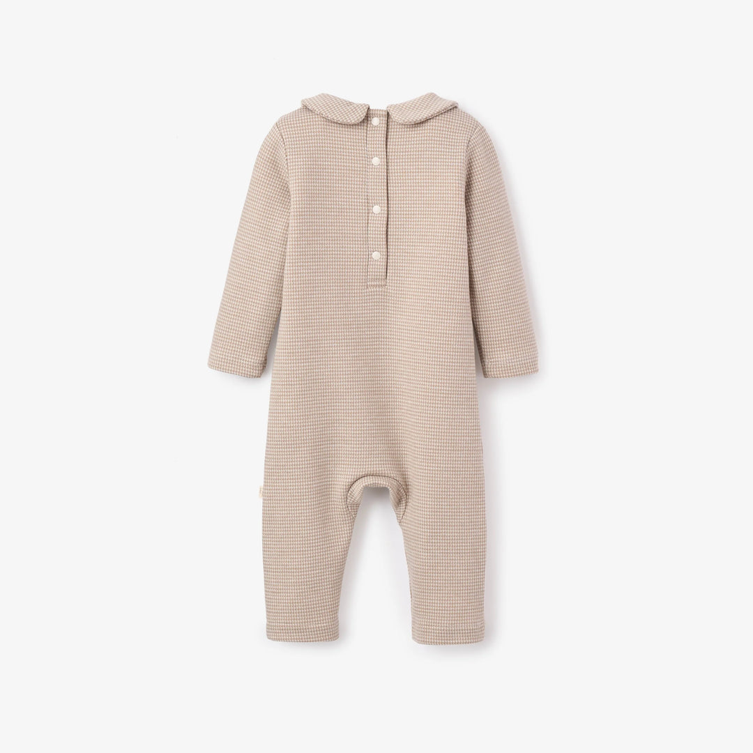Beige baby onesie with a collar on a white background