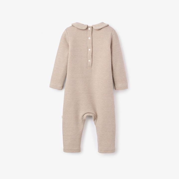 Beige baby onesie with a collar on a white background
