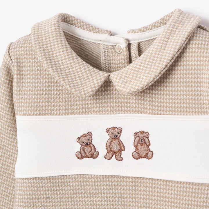 Close up of embroidered bear houndstooth baby outfit
