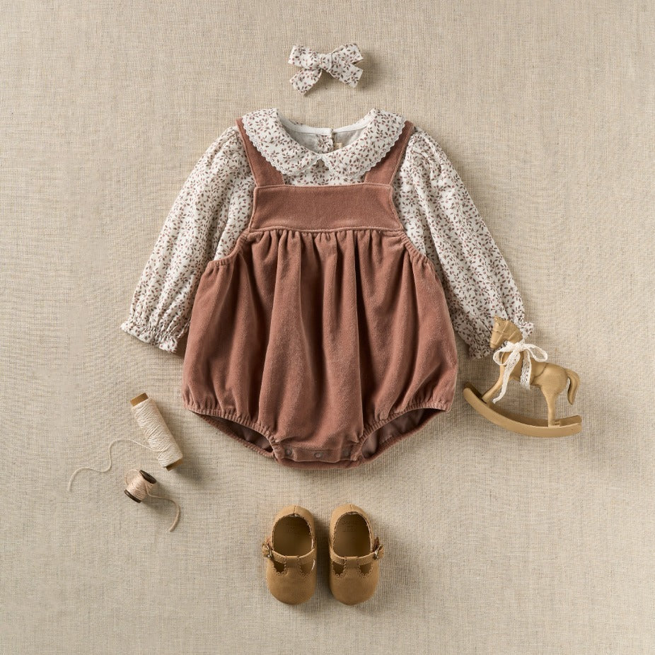 flatlay of baby girl fall outfit with accessories