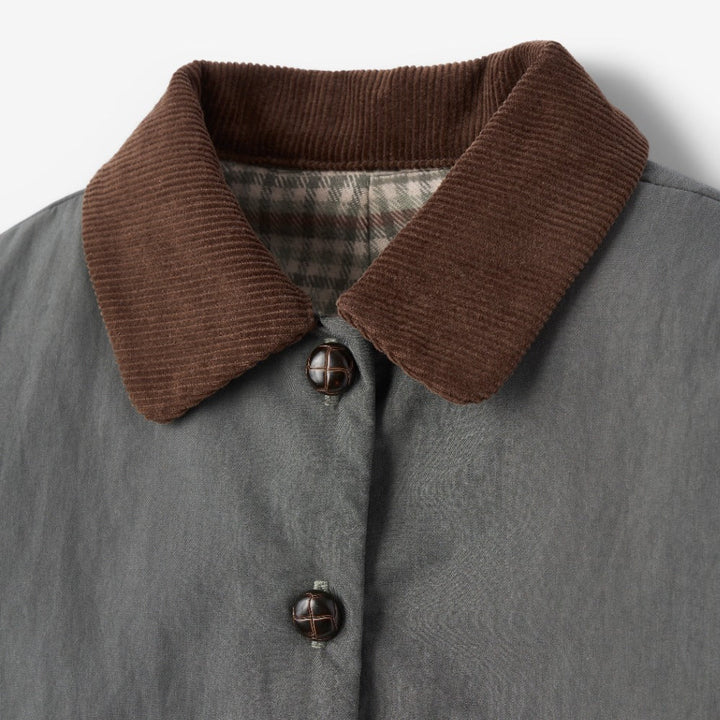 Gray coat with brown corduroy collar on a light gray background