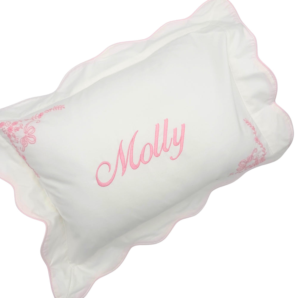 scalloped white and pink pillow case with name embroidered on front