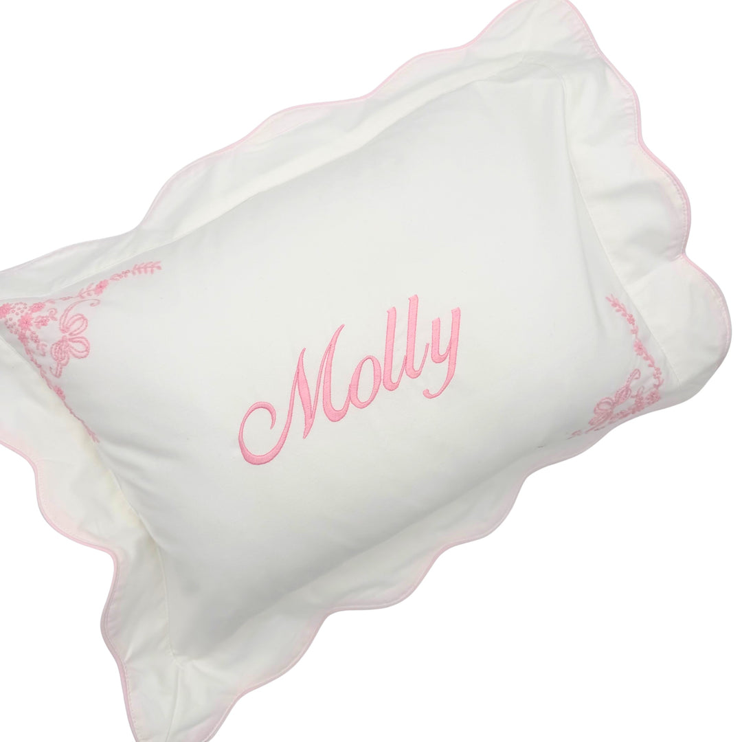 scalloped white and pink pillow case with name embroidered on front