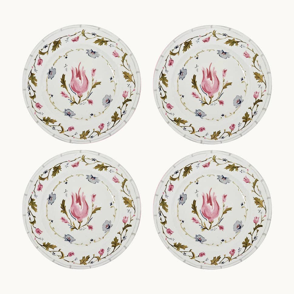 Four decorative plates with floral designs on a white background