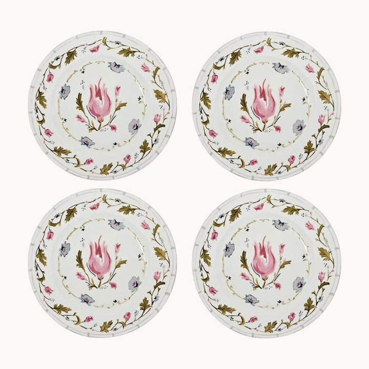 Four decorative plates with floral designs on a white background
