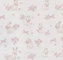 A repeating pattern of small white rabbits, pink bows, and floral motifs on a very light warm background.