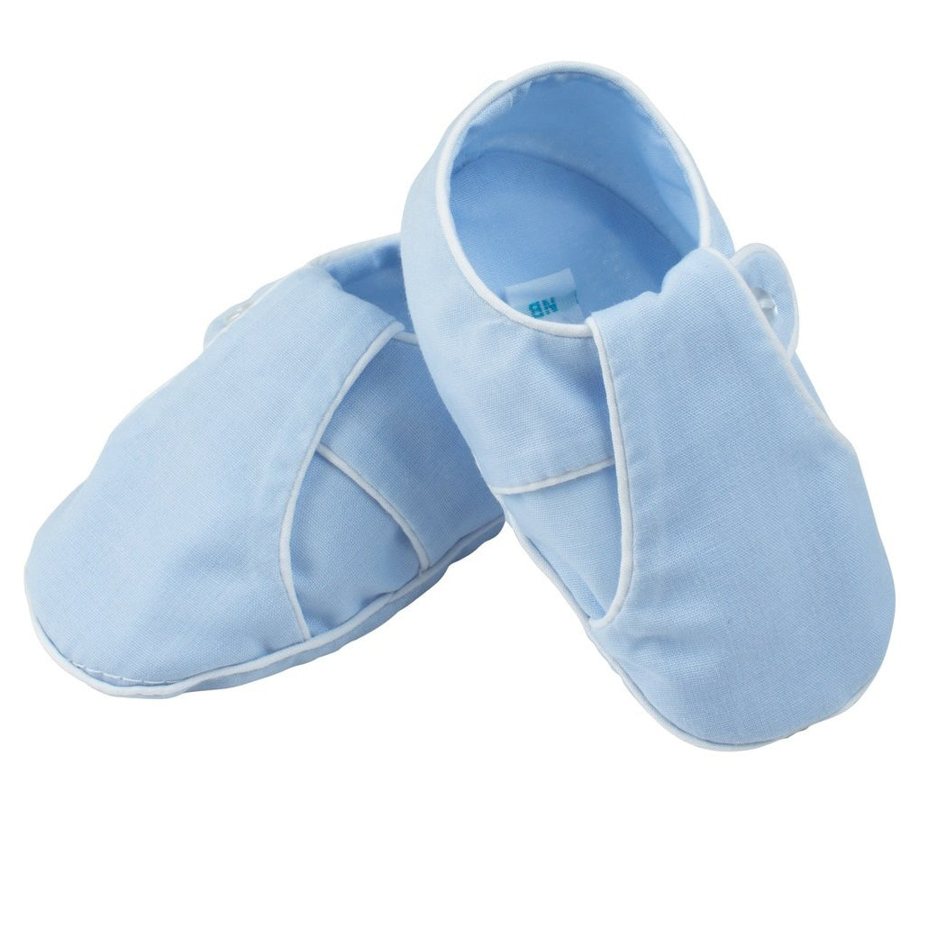 Pair of light blue baby shoes on a white background